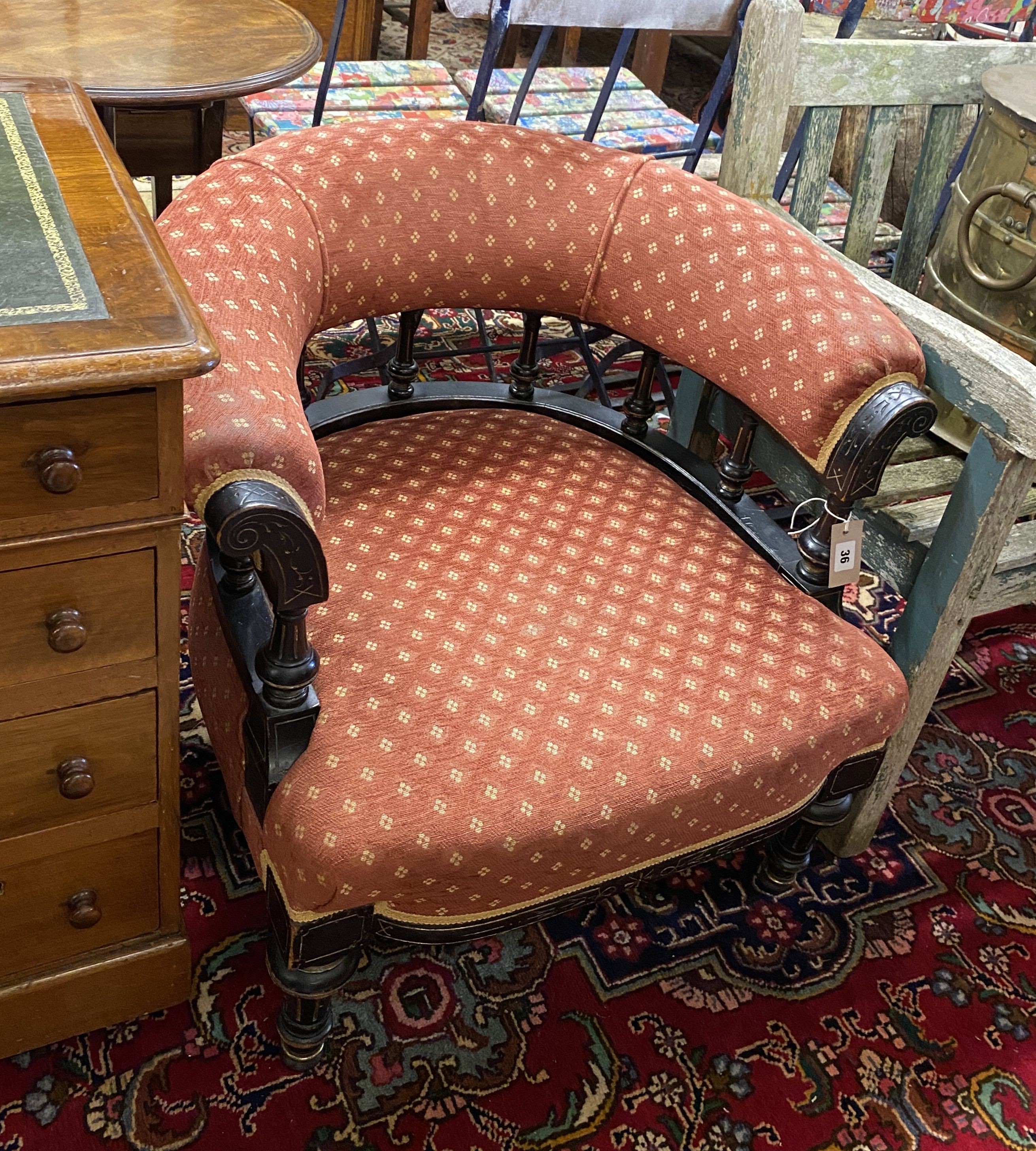 A late Victorian aesthetic movement ebonised tub framed chair, width 72cm, depth 64cm, height 66cm